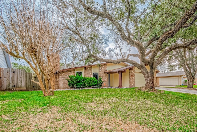 single story home with a garage and a front yard