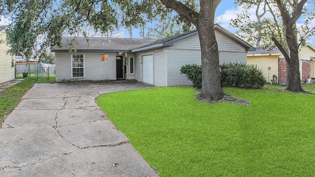 exterior space featuring a garage and a front lawn