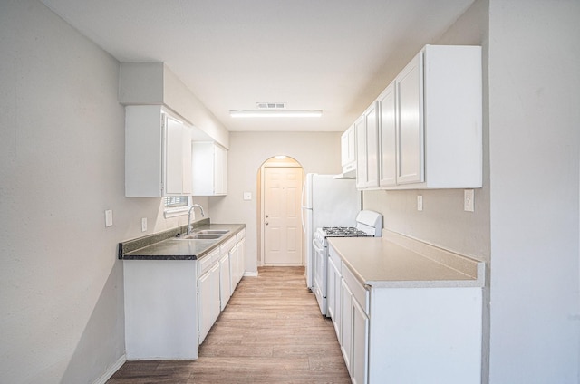 kitchen with white cabinetry, white gas range, sink, and light wood-type flooring