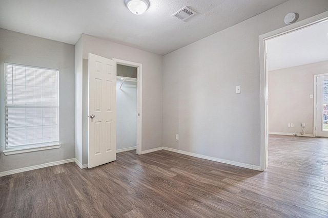 unfurnished bedroom with dark hardwood / wood-style flooring