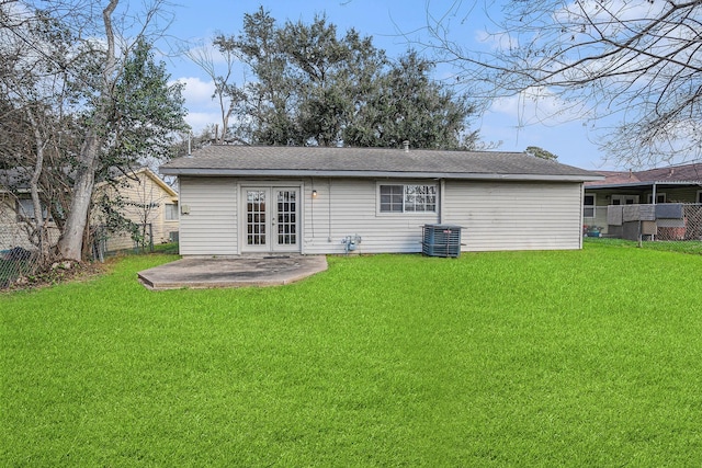 back of house featuring a patio, a yard, central AC, and french doors