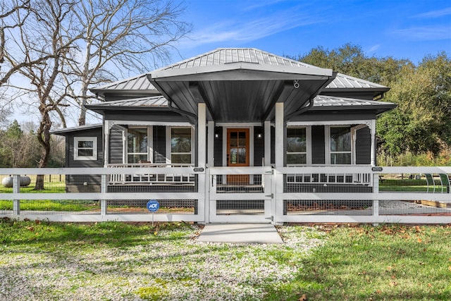 rear view of property with a lawn