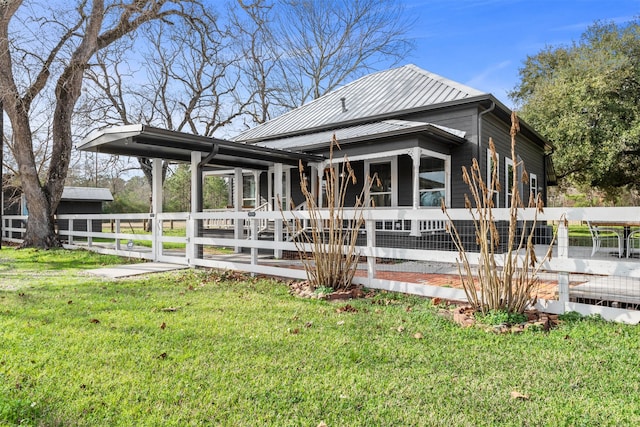 rear view of property with a lawn