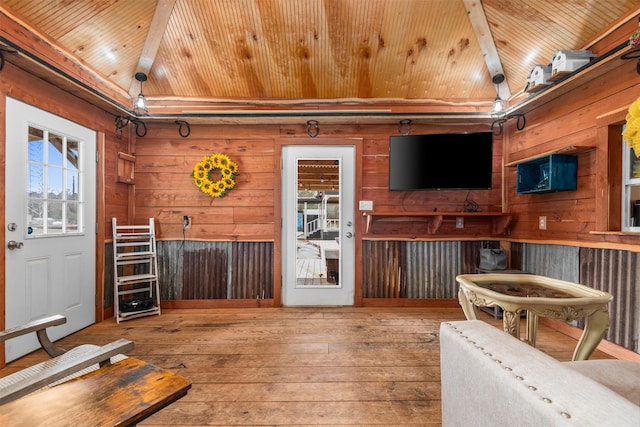 interior space with lofted ceiling, wood ceiling, hardwood / wood-style flooring, and wood walls