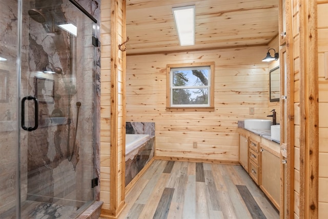 bathroom with wood walls, wooden ceiling, vanity, independent shower and bath, and hardwood / wood-style flooring