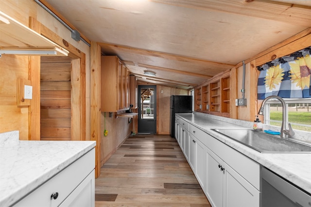 kitchen featuring white cabinetry, sink, lofted ceiling, and light hardwood / wood-style floors