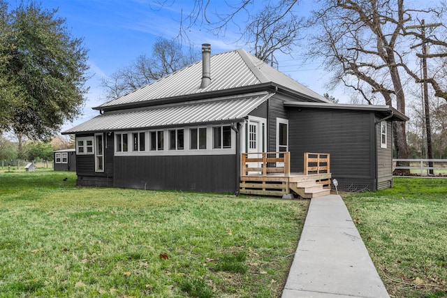 back of property with a wooden deck and a yard