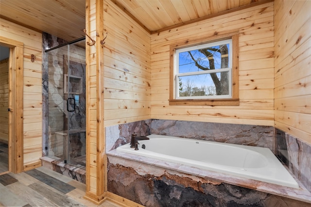 bathroom featuring separate shower and tub, hardwood / wood-style floors, wooden ceiling, and wooden walls