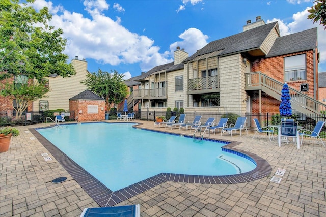 view of swimming pool with a patio