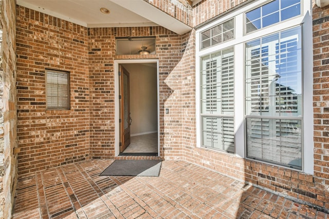 view of exterior entry featuring a patio area