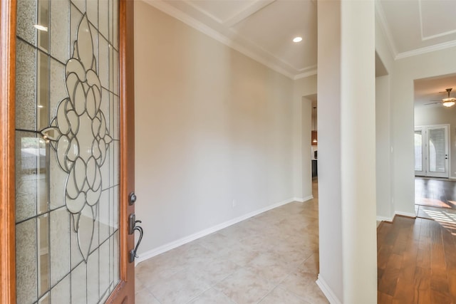 foyer with ornamental molding and ceiling fan