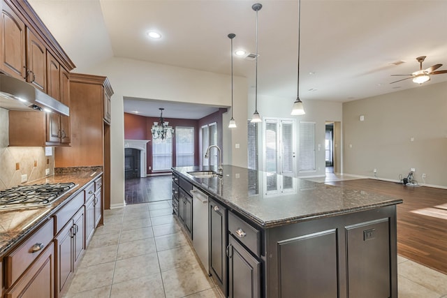 kitchen featuring hanging light fixtures, an island with sink, appliances with stainless steel finishes, and sink