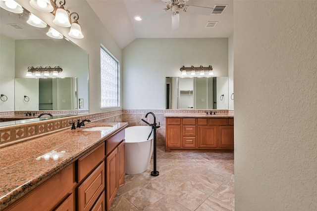 bathroom featuring a tub to relax in, vaulted ceiling, tile walls, vanity, and ceiling fan