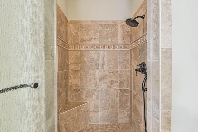 bathroom with a tile shower