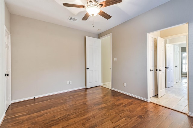 unfurnished bedroom featuring ceiling fan and hardwood / wood-style floors