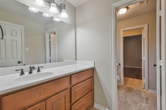 bathroom featuring vanity and toilet