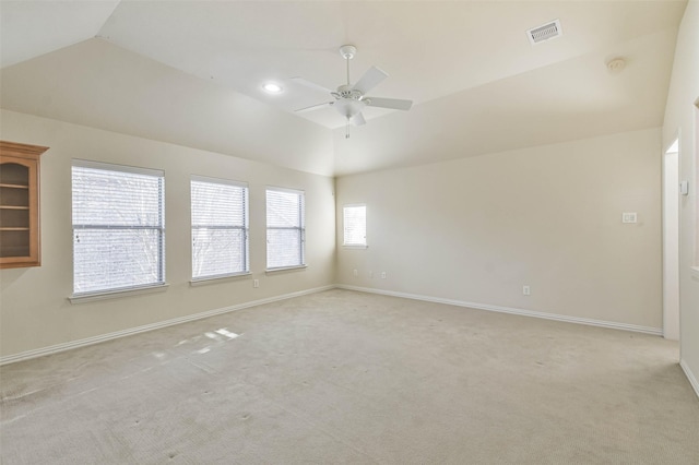 carpeted empty room with vaulted ceiling and ceiling fan