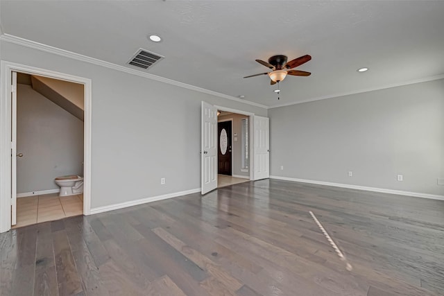 spare room with crown molding, dark hardwood / wood-style floors, and ceiling fan