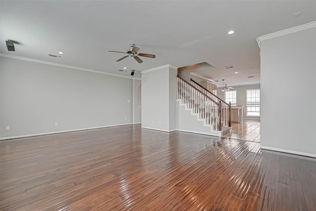 unfurnished living room with wood-type flooring, ornamental molding, and ceiling fan with notable chandelier