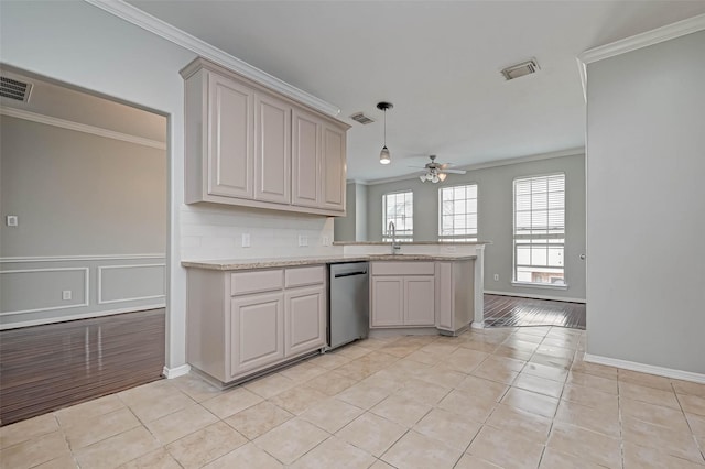 kitchen featuring sink, light tile patterned floors, hanging light fixtures, ornamental molding, and kitchen peninsula
