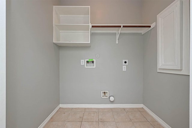 laundry area with hookup for a washing machine, gas dryer hookup, electric dryer hookup, and light tile patterned floors