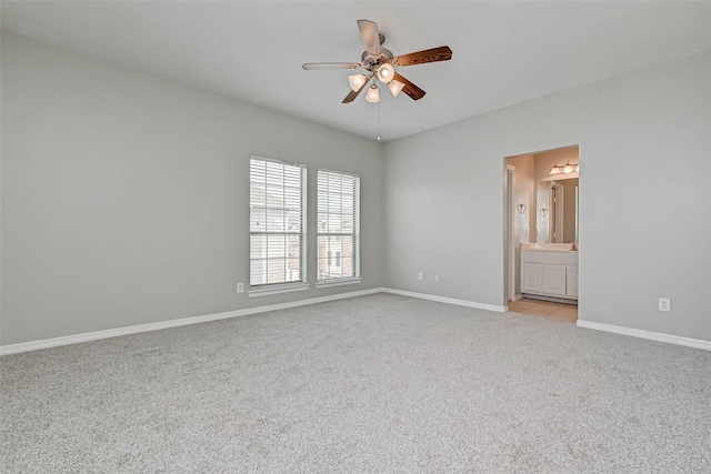 carpeted spare room with ceiling fan