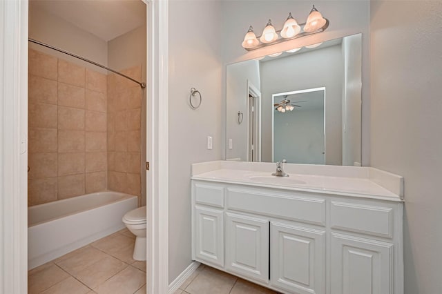 full bathroom featuring tiled shower / bath combo, vanity, ceiling fan, toilet, and tile patterned floors