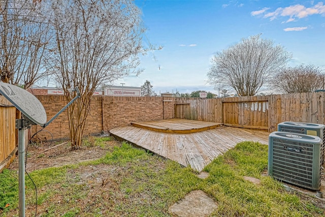 view of yard with cooling unit and a deck
