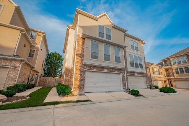 7816 Stoneyway Dr, Houston, TX 77040 - view of property featuring an attached garage, driveway, fence, brick siding, and stucco siding