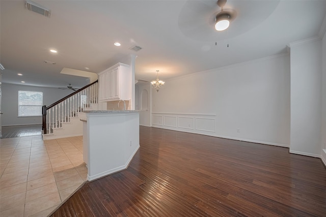 7816 Stoneyway Dr, Houston, TX 77040 - kitchen with ceiling fan, a chandelier, open floor plan, wood finished floors, and crown molding