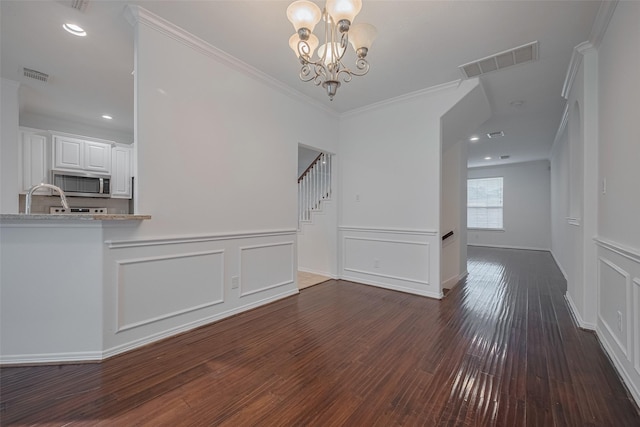 7816 Stoneyway Dr, Houston, TX 77040 - unfurnished dining area with dark wood-type flooring, a decorative wall, a chandelier, wainscoting, and crown molding