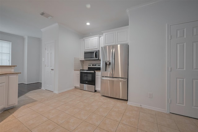 7816 Stoneyway Dr, Houston, TX 77040 - kitchen with stainless steel appliances, light tile patterned floors, crown molding, white cabinetry, and backsplash
