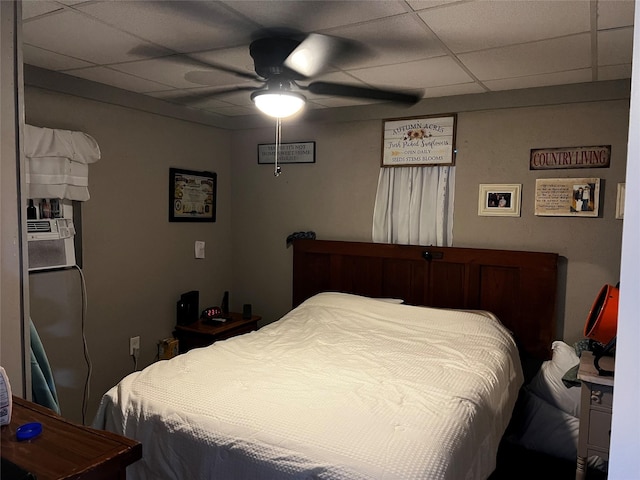 bedroom with a paneled ceiling and ceiling fan