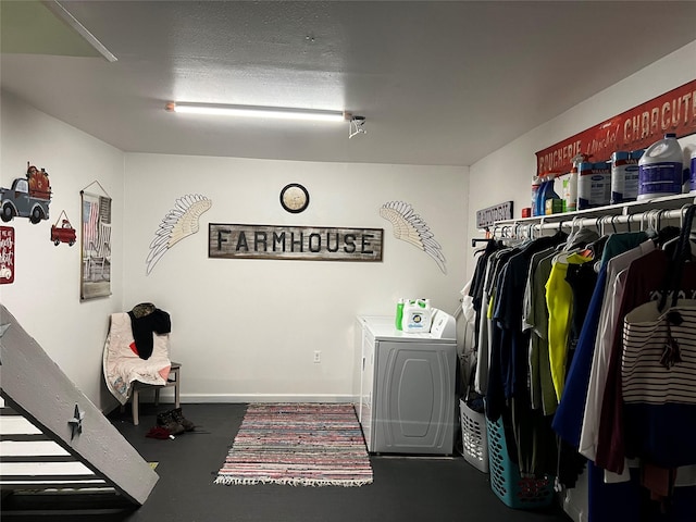 laundry area with separate washer and dryer and a textured ceiling