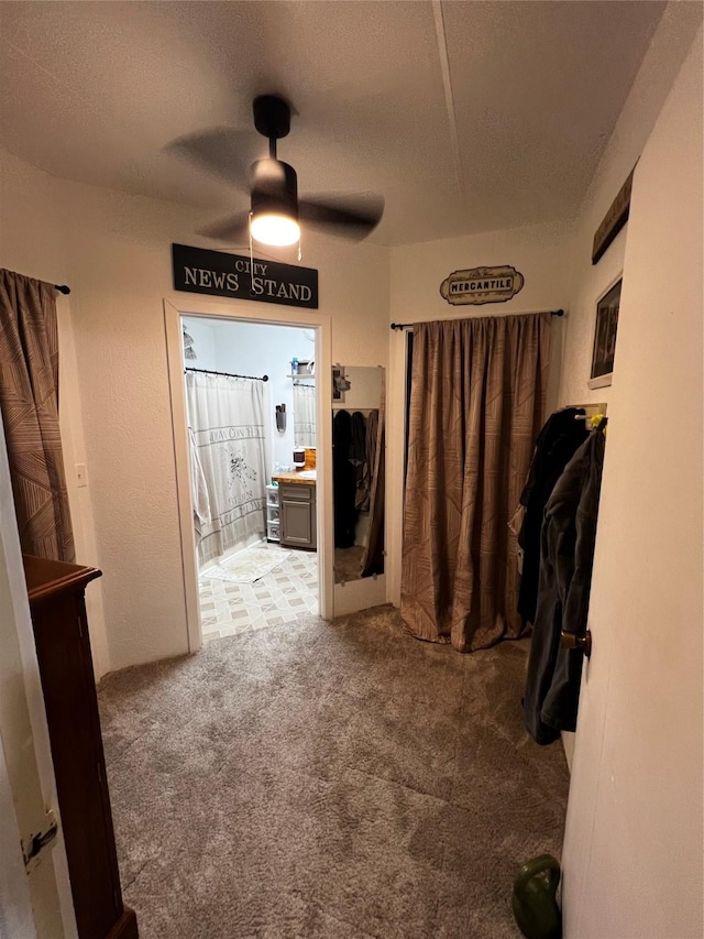 bathroom featuring a textured ceiling and ceiling fan