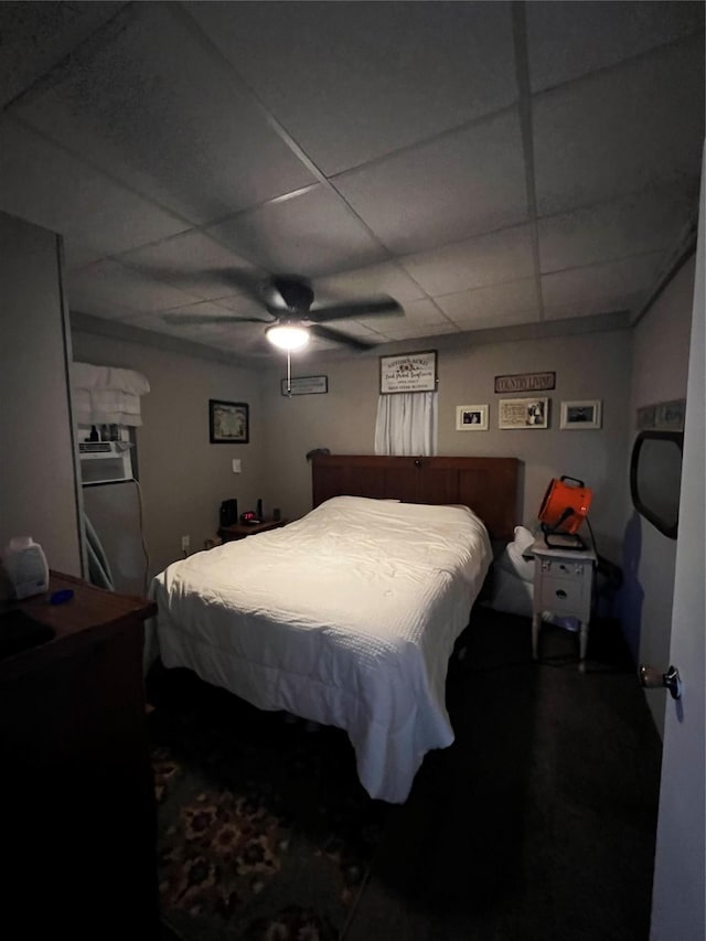 bedroom with a paneled ceiling and ceiling fan