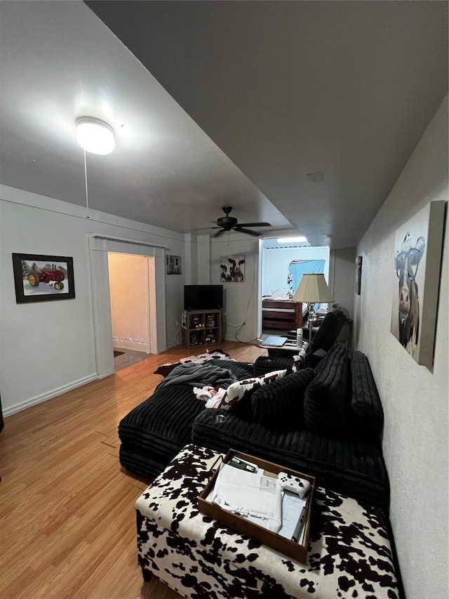 bedroom with ceiling fan and light hardwood / wood-style flooring