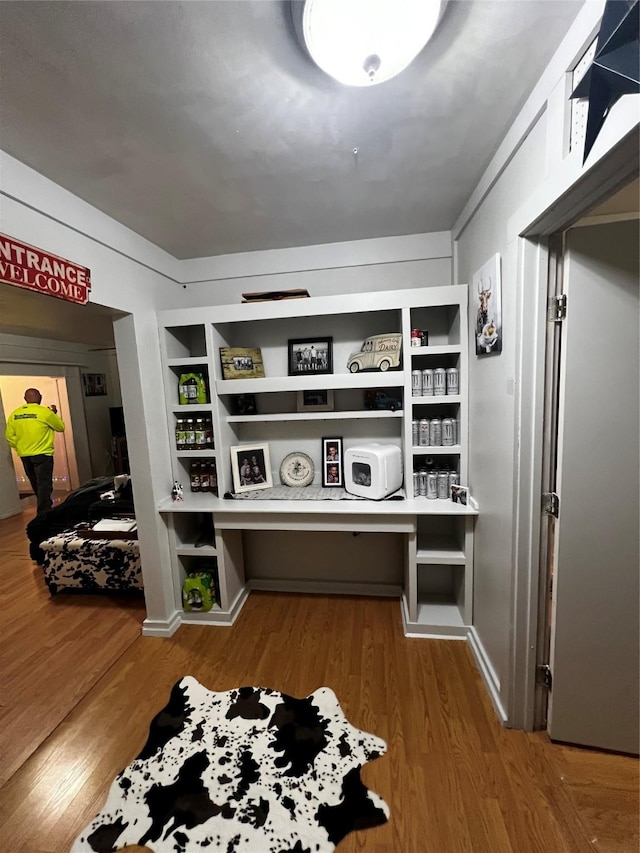 interior space featuring hardwood / wood-style flooring and built in shelves