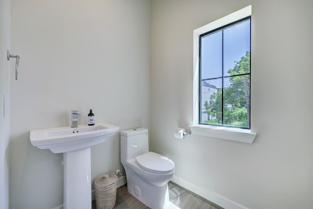 bathroom with sink, toilet, and hardwood / wood-style floors