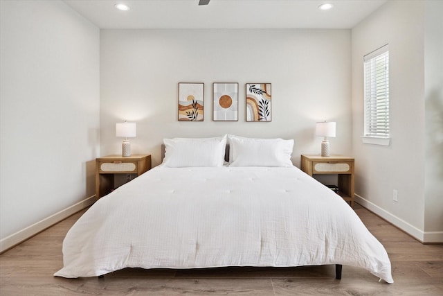 bedroom with light hardwood / wood-style floors and ceiling fan