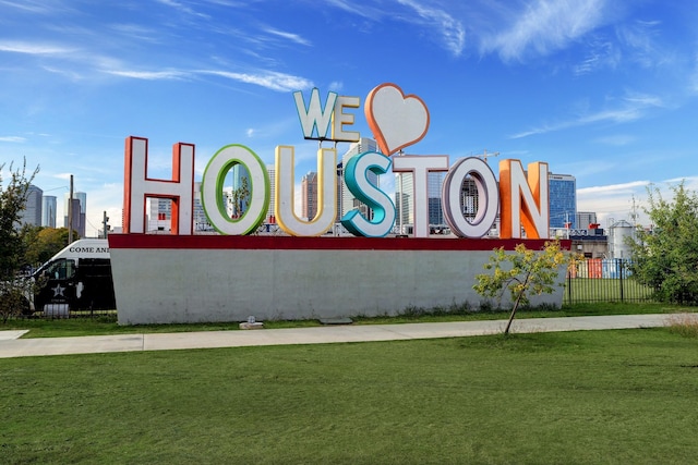 community sign featuring a lawn