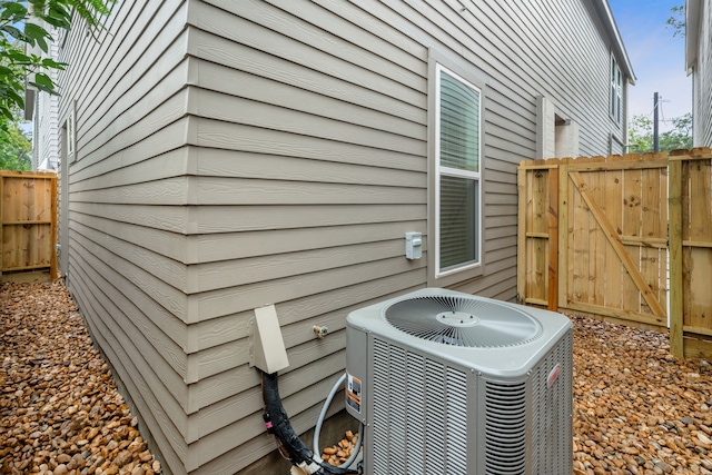 exterior details featuring cooling unit and fence