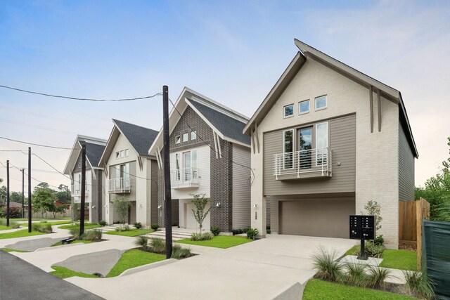 view of front facade featuring concrete driveway, brick siding, an attached garage, and fence