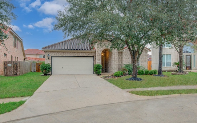 view of front of home with a garage and a front lawn