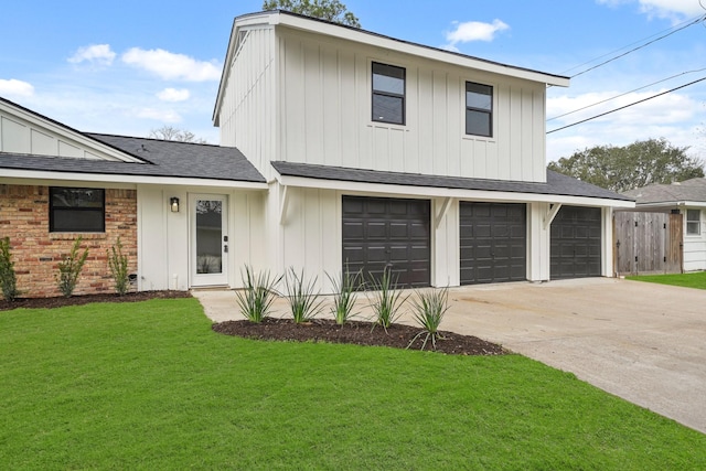 view of front of home with a garage and a front lawn