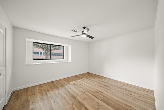 empty room with ceiling fan and light wood-type flooring