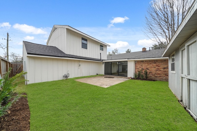 rear view of property featuring a patio and a lawn