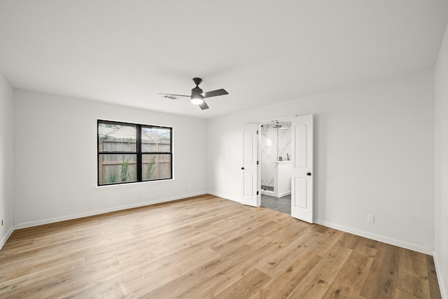 empty room featuring ceiling fan and light hardwood / wood-style floors