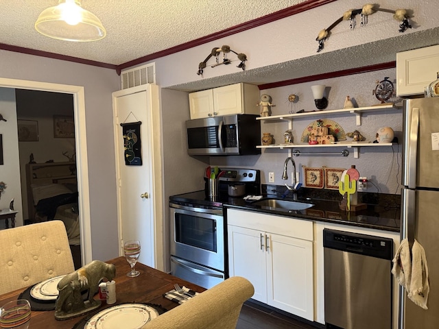 kitchen featuring white cabinetry, stainless steel appliances, crown molding, and sink