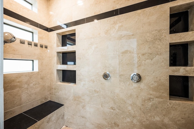 full bath featuring tiled shower